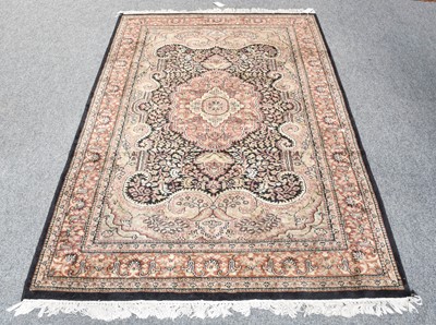 Lot 1317 - An Indian rug, the charcoal field of vines...