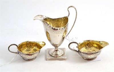 Lot 341 - A George III silver cream helmet, London 1792, also two other George III jugs, one inset with a...