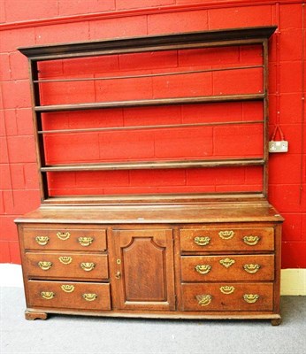 Lot 1132 - An 18th Century Joined Oak Enclosed Dresser and Rack, with five fixed shelves above a central...