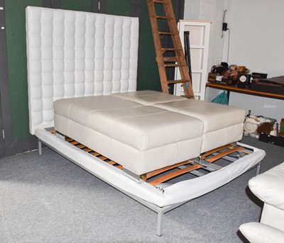 Lot 1347 - A modern white leather upholstered headboard...