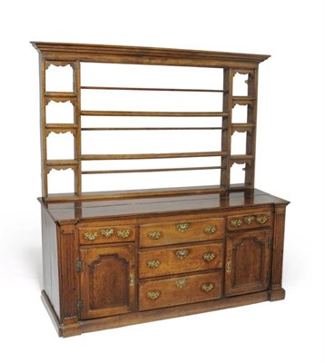 Lot 1133 - An 18th Century Oak Breakfront Dresser Base, of five drawers and two fielded cupboard doors between