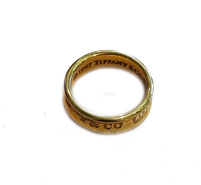 Lot 165 - A Tiffany & Co. band ring, stamped '750',...