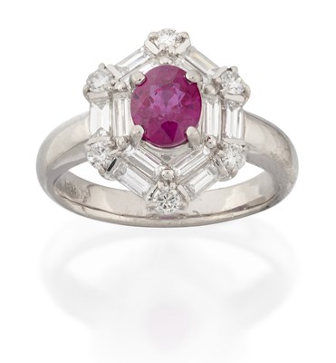 Lot 2313 - A Ruby and Diamond Cluster Ring the oval cut...