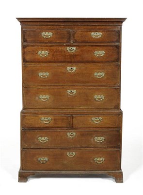 Lot 1134 - An 18th Oak and Walnut Crossbanded Chest on Chest, the cavetto cornice above an arrangement of nine