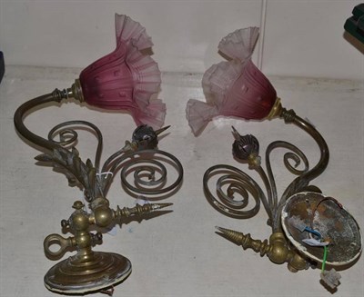 Lot 368 - Two brass wall lights with cranberry glass shades