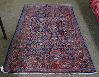 Lot 1000 - An unusual Kashan rug, the idnigo field with...