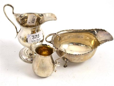 Lot 378 - Two silver jugs and a sauce boat