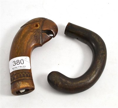 Lot 380 - An Indonesian carved horn kukri pommel as a parrot head, 19th century, with open beak and bone...