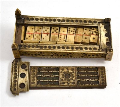 Lot 384 - A French Prisoner of War carved set of dominoes in casket, early 19th century