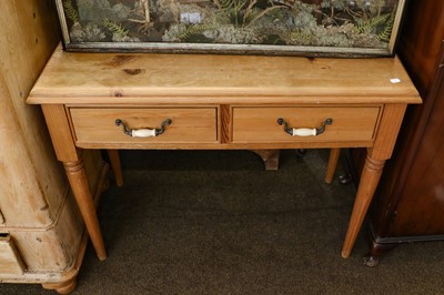 Lot 1180 - A pine two drawer side table raised on turned...