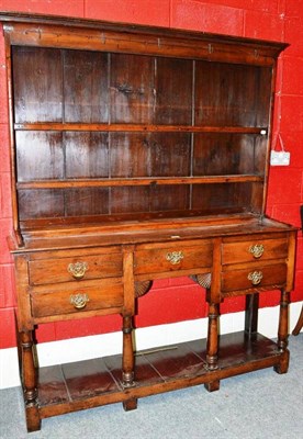 Lot 1136 - An Oak Dresser and Rack, the cavetto cornice above iron cup hooks and two fixed shelves, the...