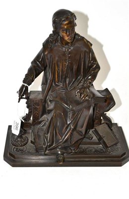 Lot 396 - A late 19th century bronze of a scholar, sitting reading with maps and books around his feet,...