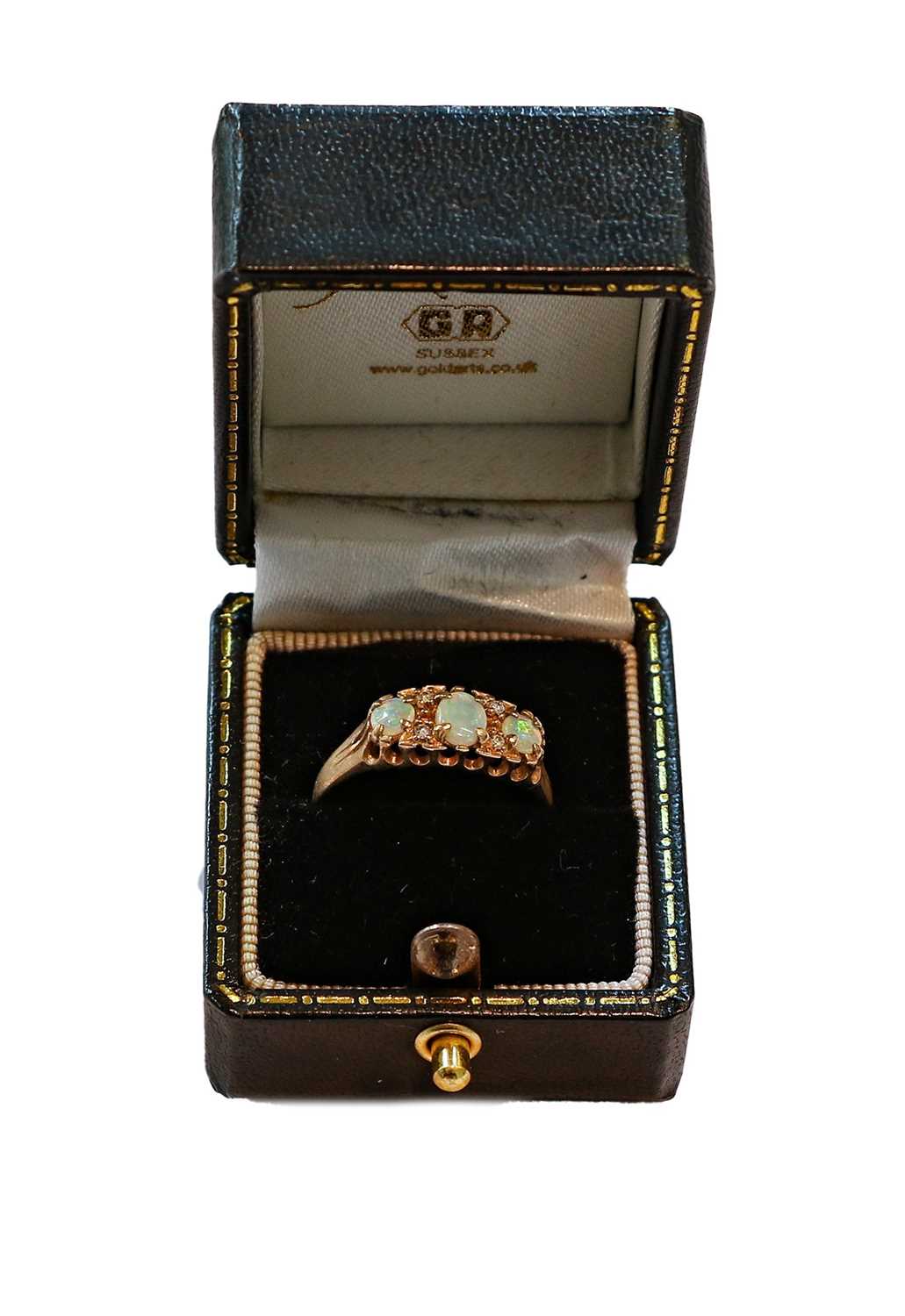 Lot 406 - A 9 Carat Gold Opal Three Stone Ring, With