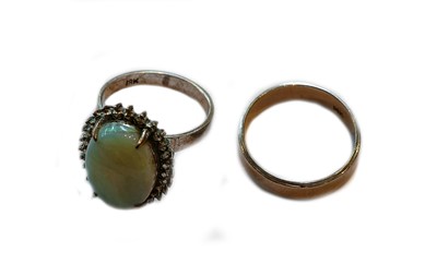 Lot 393 - A closed set opal ring, stamped ‘18K’, finger...