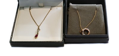 Lot 147 - A 9 carat gold ruby and diamond pendant on...