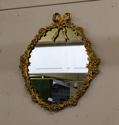 Lot 1262 - A circular wall mirror in cast gilt brass...