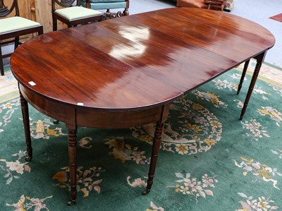 Lot 1255 - Small George III mahogany dining table of two...