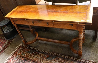 Lot 1111 - A oak fold out single drawer dining table...