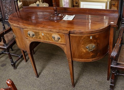 Lot 1135 - A Regency inlaid mahogany bow front sideboard...