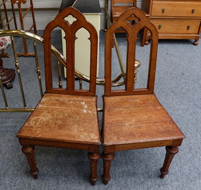 Lot 1243 - A pair of oak gothic revival hall chairs...