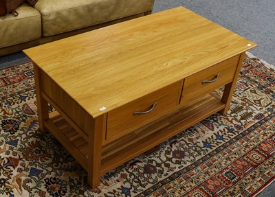 Lot 1219 - A modern light oak two drawer coffee table,...