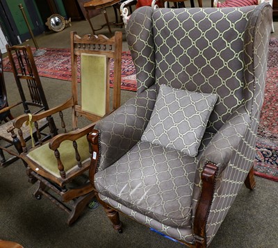 Lot 1148 - A Victorian upholstered wing back armchair on...