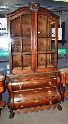 Lot 509 - A 18th century style Continental oak cabinet on bombe base