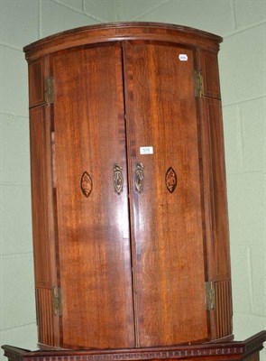 Lot 515 - 18th century oak and mahogany cross banded corner cupboard