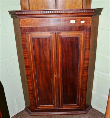 Lot 516 - George III mahogany corner cupboard with dentil cornice