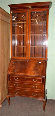 Lot 517 - A 1920's mahogany bureau bookcase