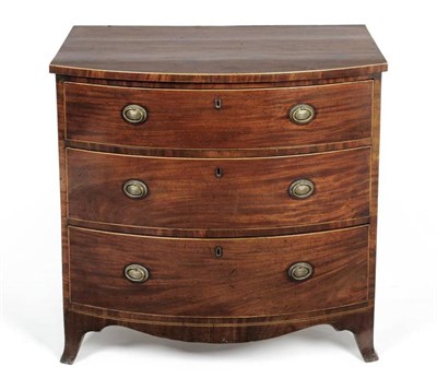 Lot 1151 - A Regency Mahogany Bowfront Chest of Drawers, early 19th century, of three graduated drawers,...