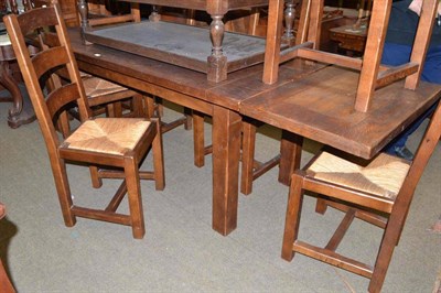 Lot 536 - A reproduction oak extending dining table and a set of eight similar ladder back dining chairs