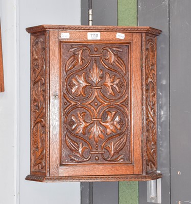 Lot 1110 - A 20th century hanging carved oak corner...