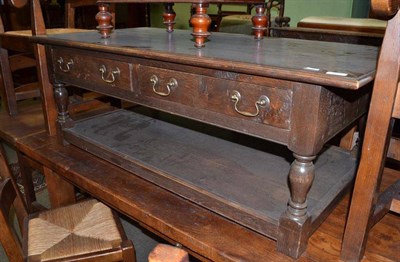 Lot 543 - An oak coffee table fitted with two drawers