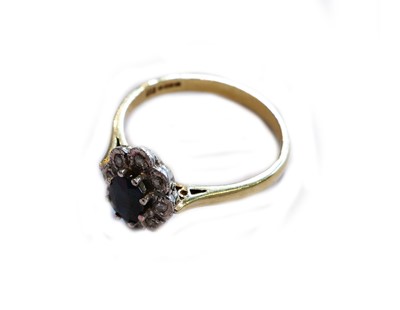 Lot 183 - A 14 carat gold sapphire and diamond cluster...