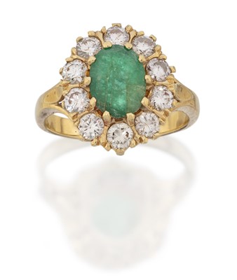 Lot 210 - An emerald and diamond cluster ring, the oval...