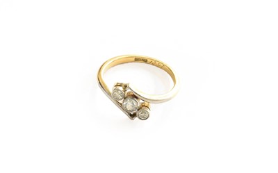 Lot 212 - A diamond three stone twist ring, stamped...