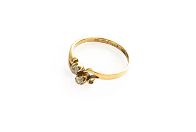 Lot 234 - An 18 carat gold diamond two stone twist ring,...