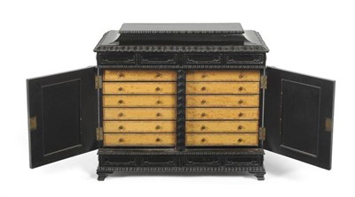 Lot 1153 - A Victorian Ebonised Collectors' Table Cabinet, late 19th century, the hinged lid above two...