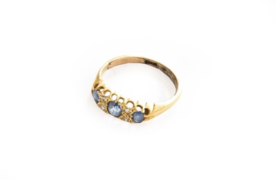 Lot 216 - A sapphire three stone ring with diamond...
