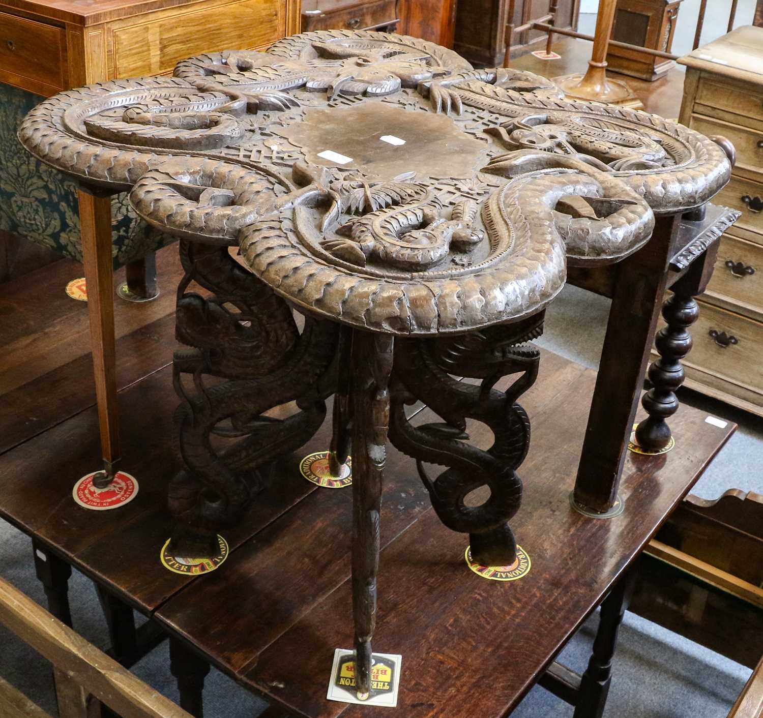 Lot 1124 - A Burmese carved hardwood table, decorated...