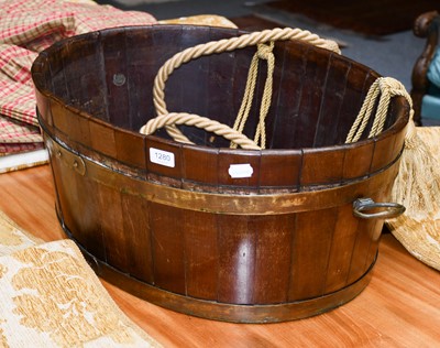 Lot 1280 - A staved ovoid formed planter with brass carry...