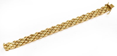 Lot 240 - A fancy link bracelet, stamped '750', length...