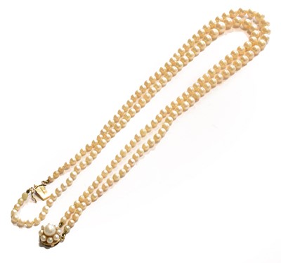 Lot 265 - A double row cultured pearl necklace, knotted...