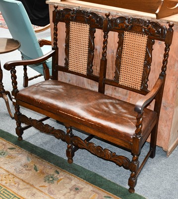 Lot 1294 - A carved oak two seater bench, the cresting...