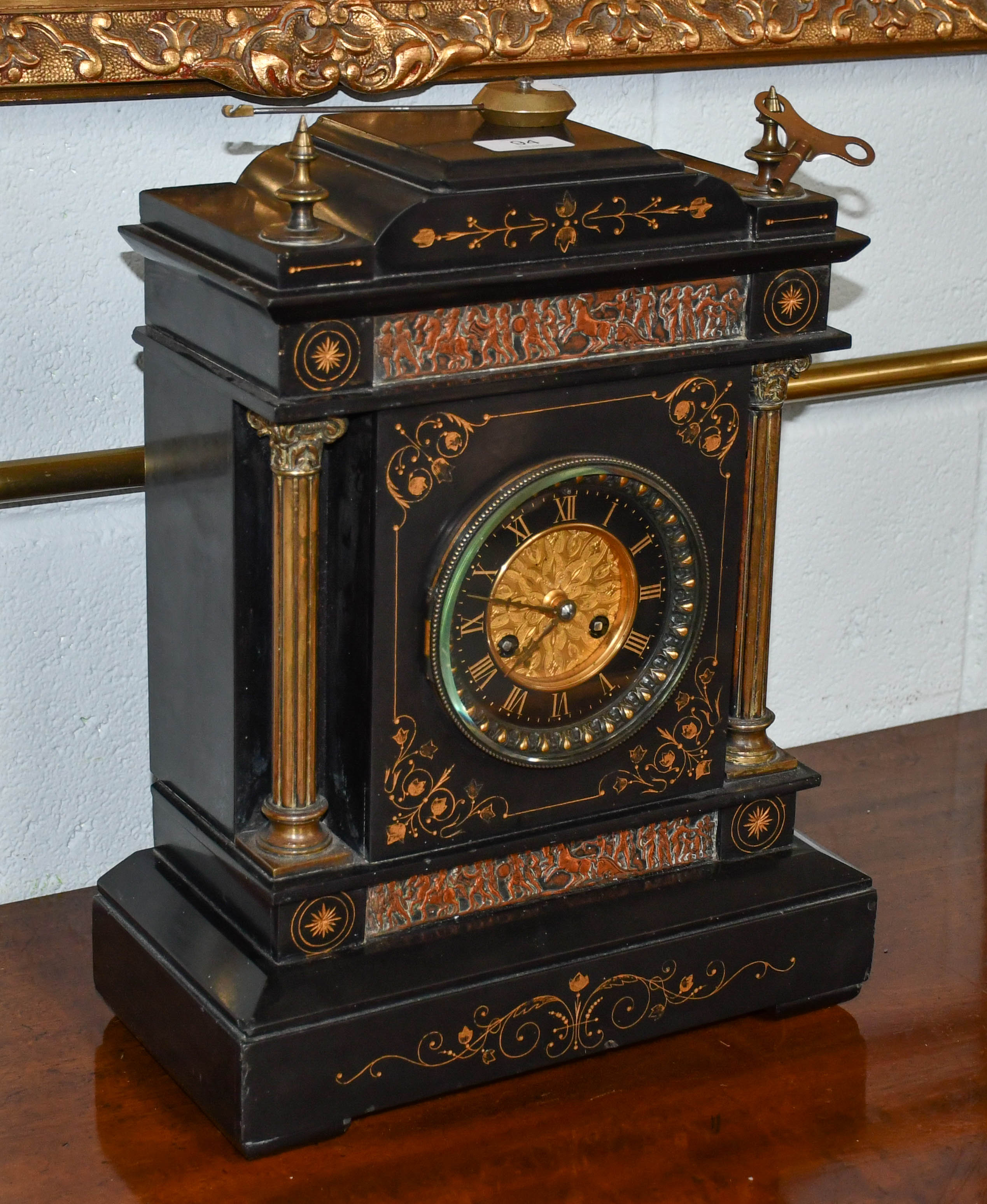 Lot 94 A Victorian black slate striking mantel clock,
