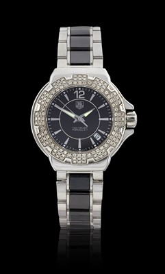 Lot 2167 - Tag Heuer: A Lady's Stainless Steel Diamond Set Calendar Centre Seconds Wristwatch