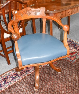 Lot 1150 - An early 20th century carved oak swivel chair