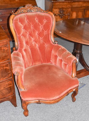 Lot 1171 - A Victorian buttoned armchair with carved...