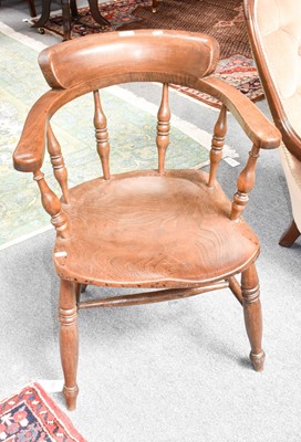 Lot 1164 - A 20th century elm smokers chair